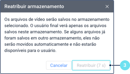 A caixa de diálogo de confirmação 'Reatribuir armazenamento'. Ela exibe um aviso de que os arquivos existentes não serão movidos automaticamente. O destaque 3 aponta para o botão 'Reatribuir', que está temporariamente desativado e mostra um temporizador de contagem regressiva.